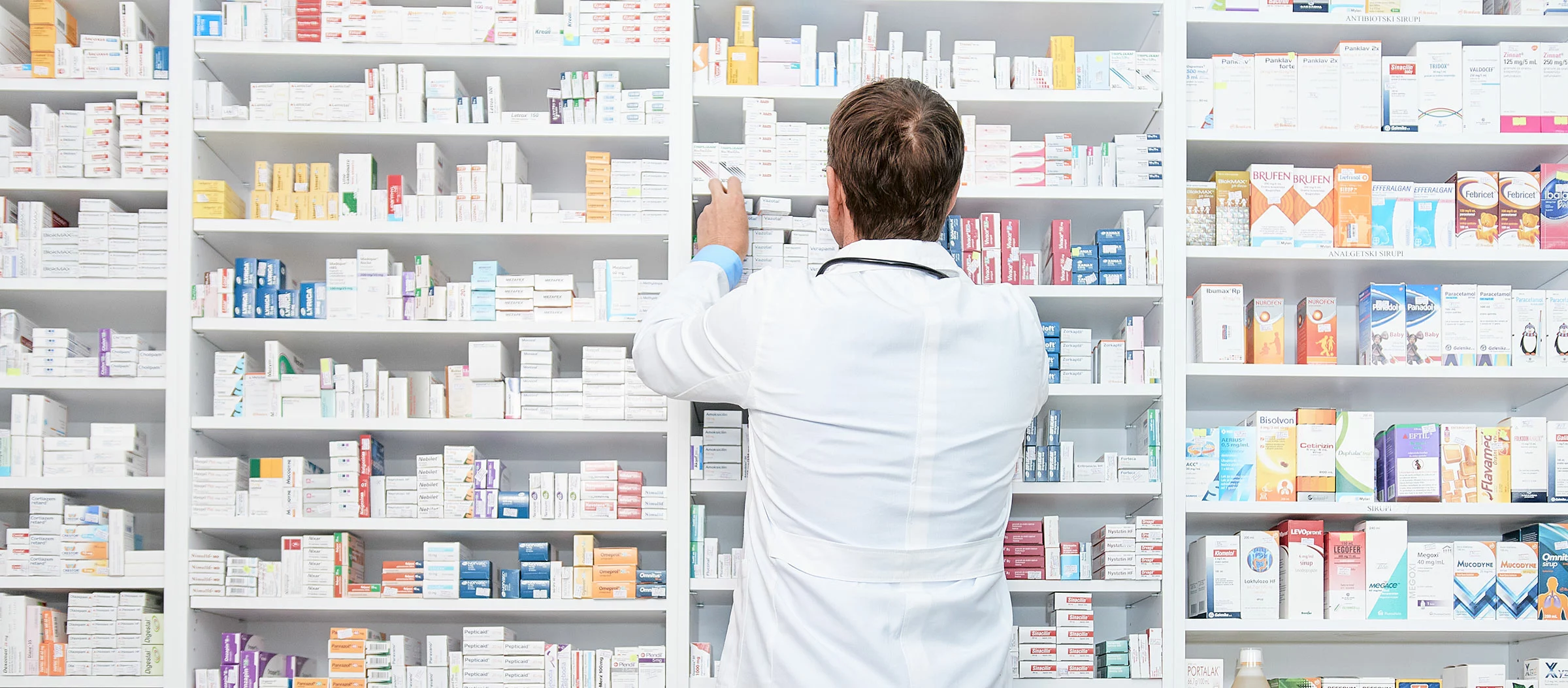 Pharmacist putting medicine on shelves